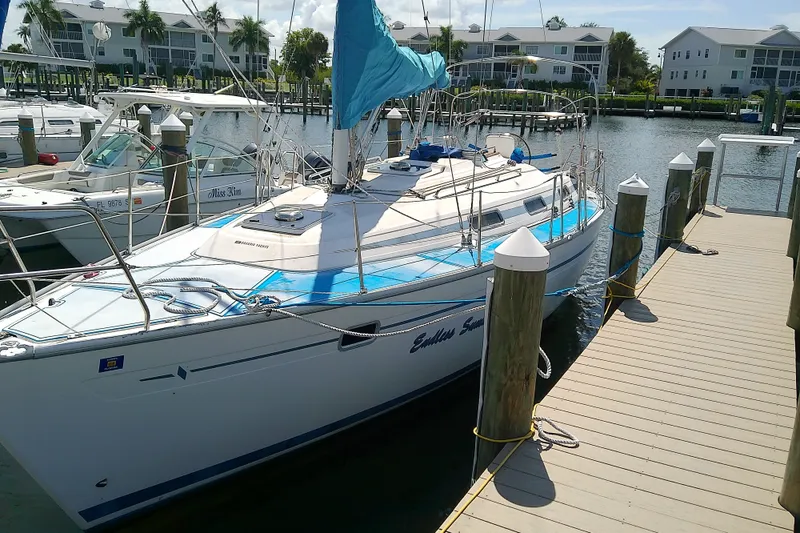 Slide: The Image of Sailboat Bavaria Cruiser 37, 2001 model, docked at marina with blue sail cover. - 3