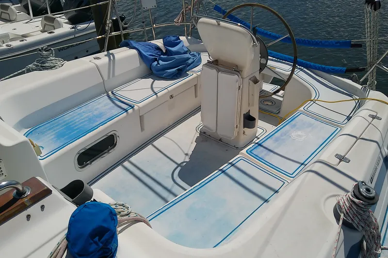 Slide: The Image of Cockpit of a 2001 Bavaria Cruiser 37 sailboat with steering wheel and seating. - 10
