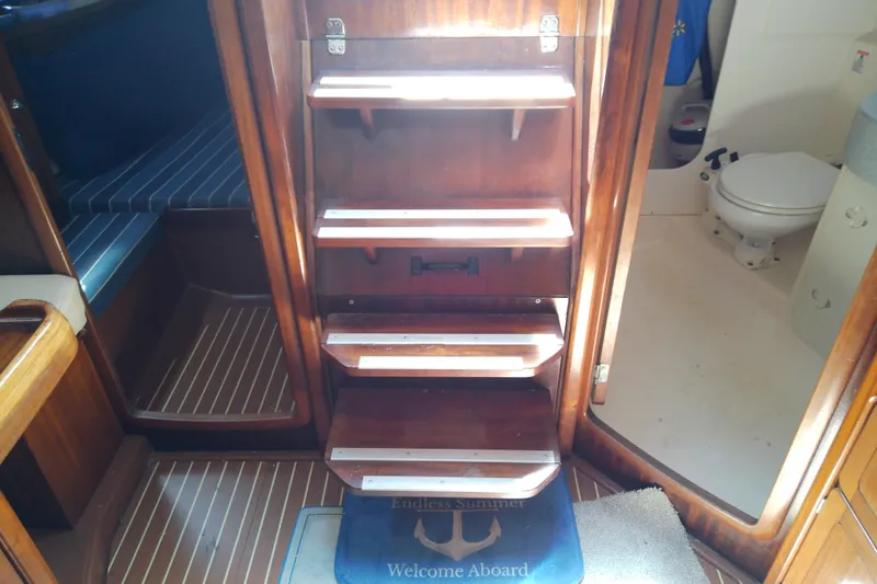 Slide: The Image of Interior of 2001 Bavaria Cruiser 37 yacht with wooden steps and visible bathroom. - 28