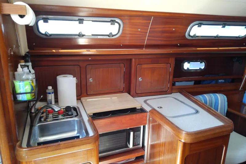 Slide: The Image of Interior of 2001 Bavaria Cruiser 37 yacht kitchen with wooden cabinets and appliances. - 25