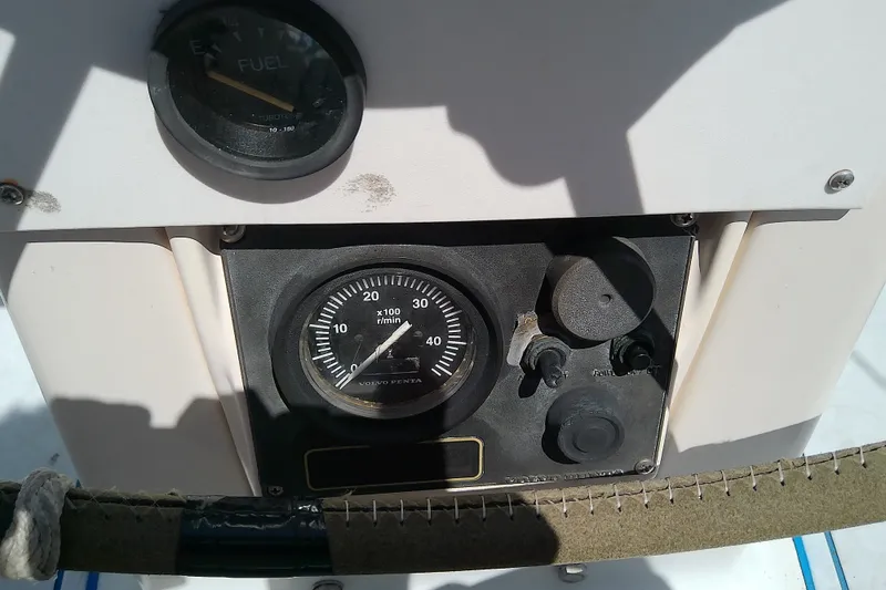 Slide: The Image of Control panel of a 2001 Bavaria Cruiser 37 sailboat, featuring fuel and RPM gauges. - 14