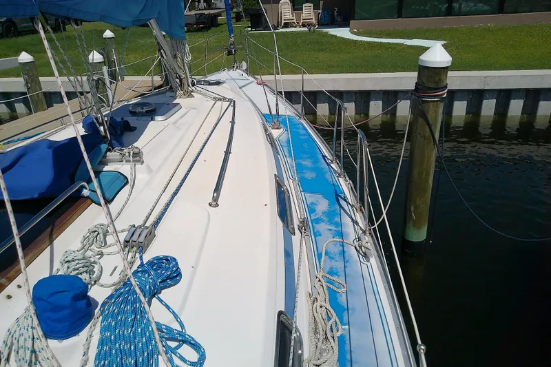 Slide: The Image of Sailboat Bavaria Cruiser 37, 2001 model, docked with visible deck and rigging. - 15
