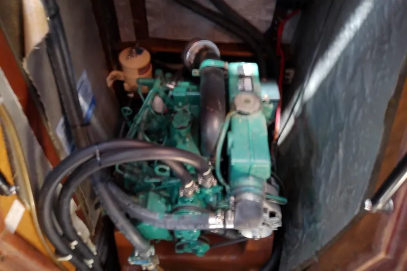 Slide: The Image of Engine compartment of a 2001 Bavaria Cruiser 37 sailboat, featuring hoses and components. - 32