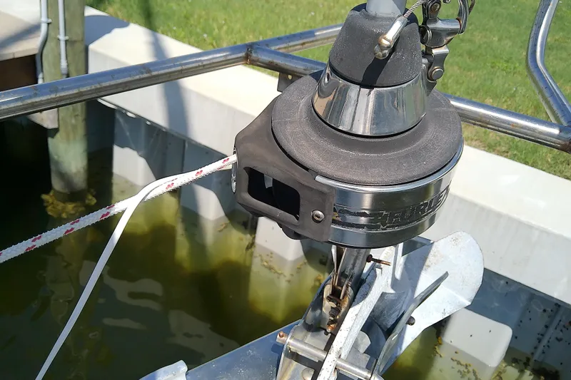 Slide: The Image of Anchor system on a 2001 Bavaria Cruiser 37 sailboat, docked by the water. - 8
