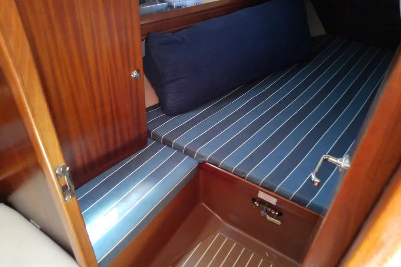 Slide: The Image of Interior cabin of 2001 Bavaria Cruiser 37 with striped cushions and wooden finish. - 37