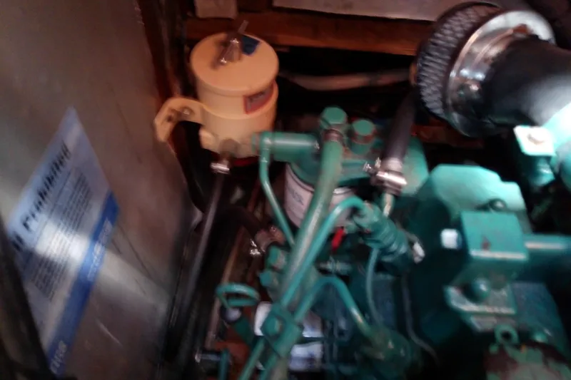 Slide: The Image of Engine compartment of a 2001 Bavaria Cruiser 37 sailboat, showing mechanical components. - 36