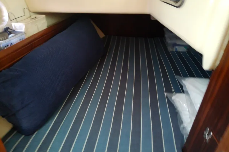 Slide: The Image of Interior cabin of a 2001 Bavaria Cruiser 37 sailboat with striped bedding. - 38