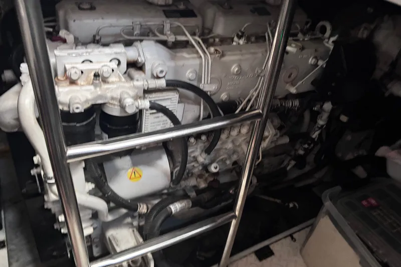 Slide: The Image of Engine compartment of a 2004 Cruisers Yachts 455 Express Motoryacht, showcasing mechanical components. - 20