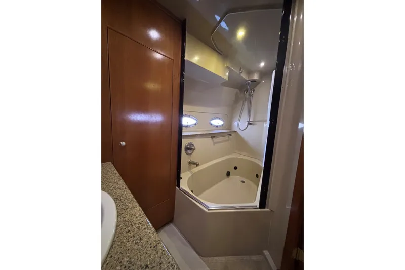 Slide: The Image of Luxurious bathroom in 2004 Cruisers Yachts 455 Express Motoryacht with shower and tub. - 46