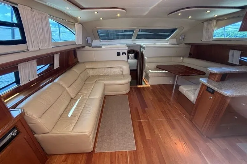 Slide: The Image of Luxurious interior of 2004 Cruisers Yachts 455 Express Motoryacht with leather seating and wood finishes. - 22