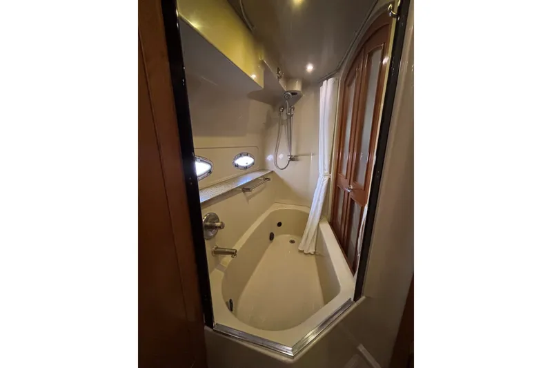 Slide: The Image of Luxurious bathroom in 2004 Cruisers Yachts 455 Express Motoryacht with bathtub and shower. - 47