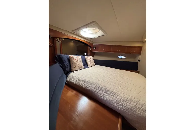 Slide: The Image of Luxurious bedroom interior of 2004 Cruisers Yachts 455 Express Motoryacht with elegant bedding. - 33