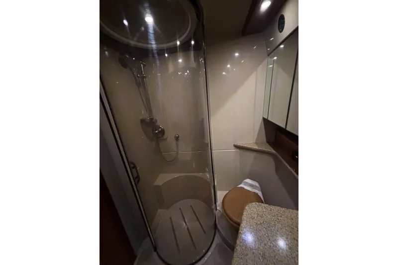 Slide: The Image of Luxurious bathroom in 2004 Cruisers Yachts 455 Express Motoryacht with shower and granite countertop. - 37