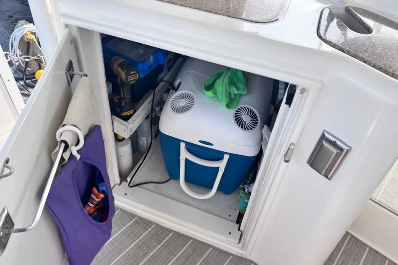 Slide: The Image of Storage compartment on 2004 Cruisers Yachts 455 Express Motoryacht with cooler and tools. - 13