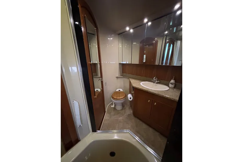 Slide: The Image of Luxurious bathroom in 2004 Cruisers Yachts 455 Express Motoryacht with wood accents and modern fixtures. - 48