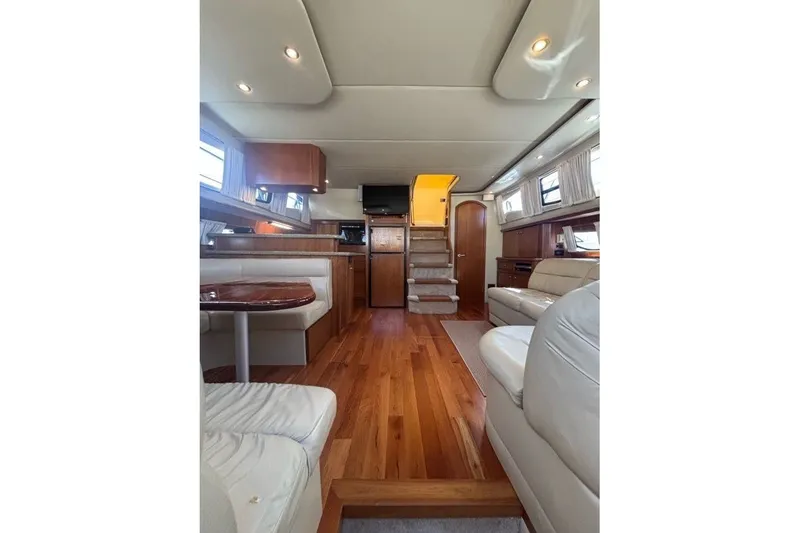 Slide: The Image of Luxurious interior of 2004 Cruisers Yachts 455 Express Motoryacht with wood flooring and plush seating. - 28