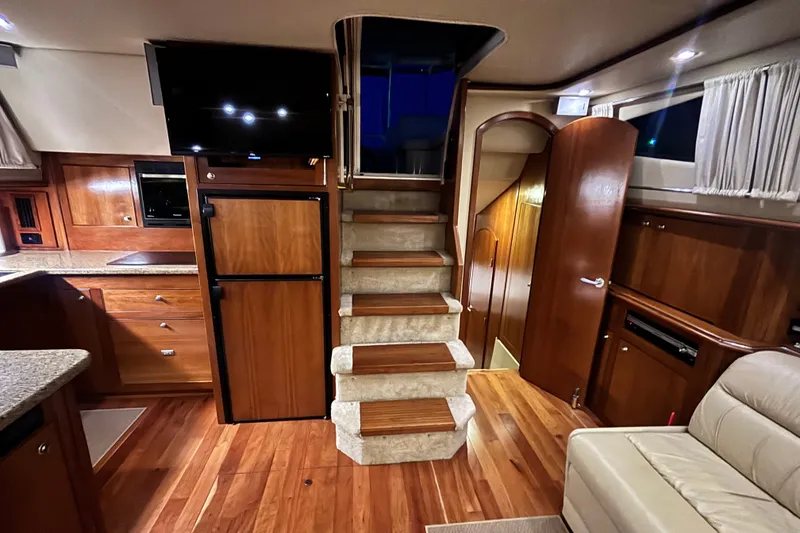 Slide: The Image of Luxurious interior of 2004 Cruisers Yachts 455 Express Motoryacht with wooden cabinetry and stairs. - 29