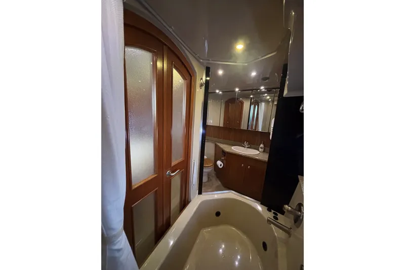 Slide: The Image of Luxurious bathroom in 2004 Cruisers Yachts 455 Express Motoryacht with elegant wood accents. - 45