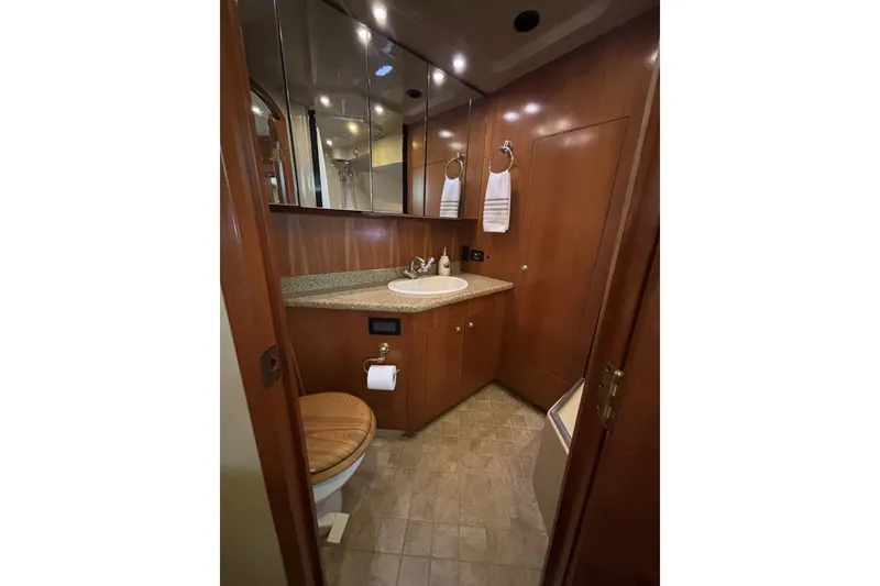 Slide: The Image of Luxurious bathroom in 2004 Cruisers Yachts 455 Express Motoryacht with wood cabinetry and modern fixtures. - 44