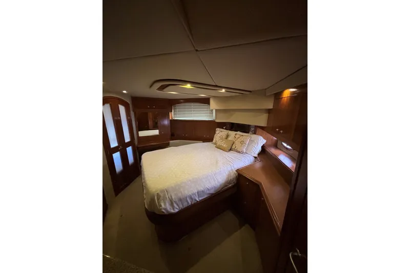 Slide: The Image of Luxurious bedroom interior of 2004 Cruisers Yachts 455 Express Motoryacht with elegant wood finish. - 42