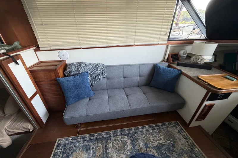 Slide: The Image of Interior of 1987 Carver 32 Aft Cabin Motor Yacht with cozy seating and decor. - 22
