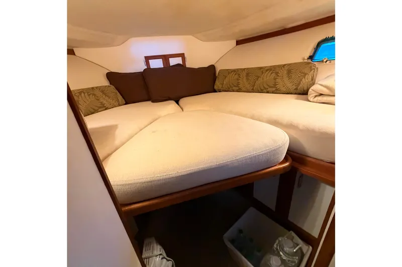 Slide: The Image of Cozy cabin interior of 1987 Carver 32 Aft Cabin Motor Yacht with plush bedding. - 30