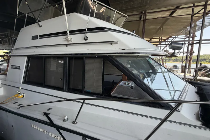 Slide: The Image of 1987 Carver 32 Aft Cabin Motor Yacht docked in a marina. - 5