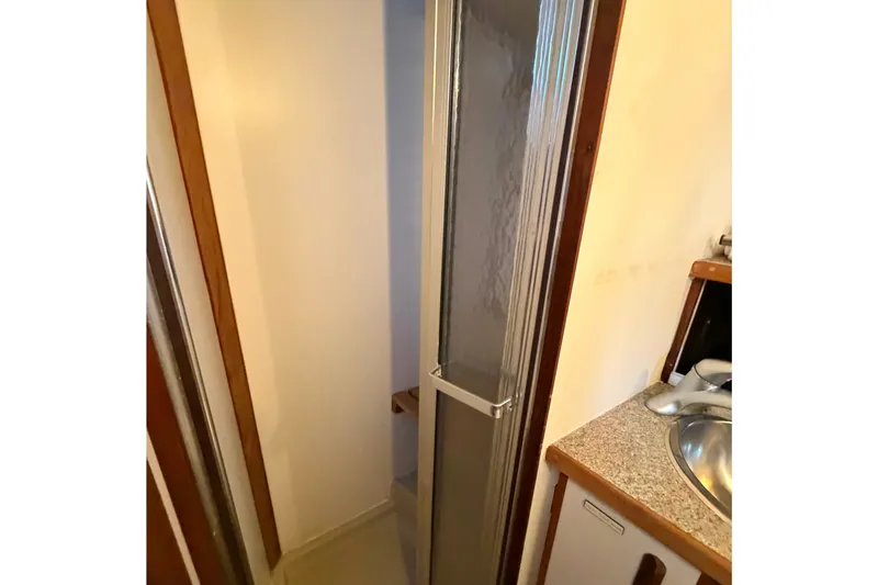 Slide: The Image of 1987 Carver 32 Aft Cabin Motor Yacht bathroom with shower and sink. - 32