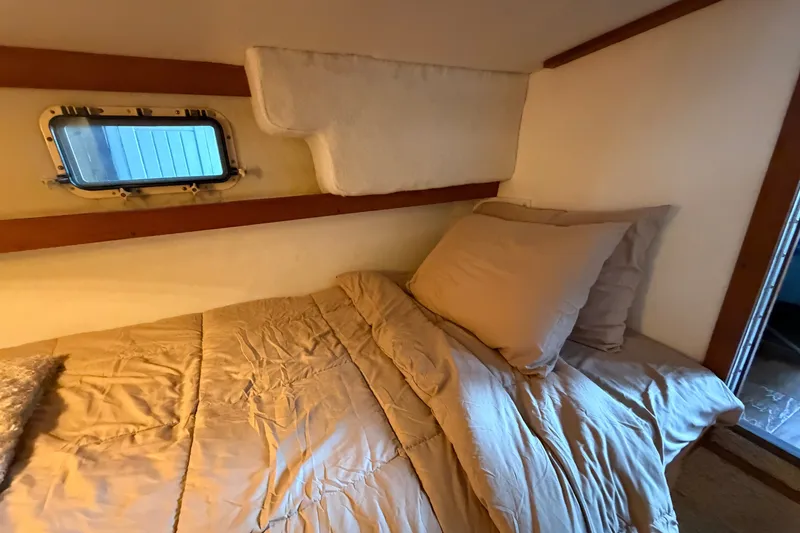 Slide: The Image of Cozy cabin bedroom in 1987 Carver 32 Aft Cabin Motor Yacht with window view. - 42