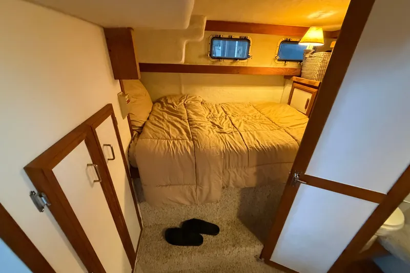 Slide: The Image of Cozy bedroom in 1987 Carver 32 Aft Cabin Motor Yacht with warm lighting. - 38
