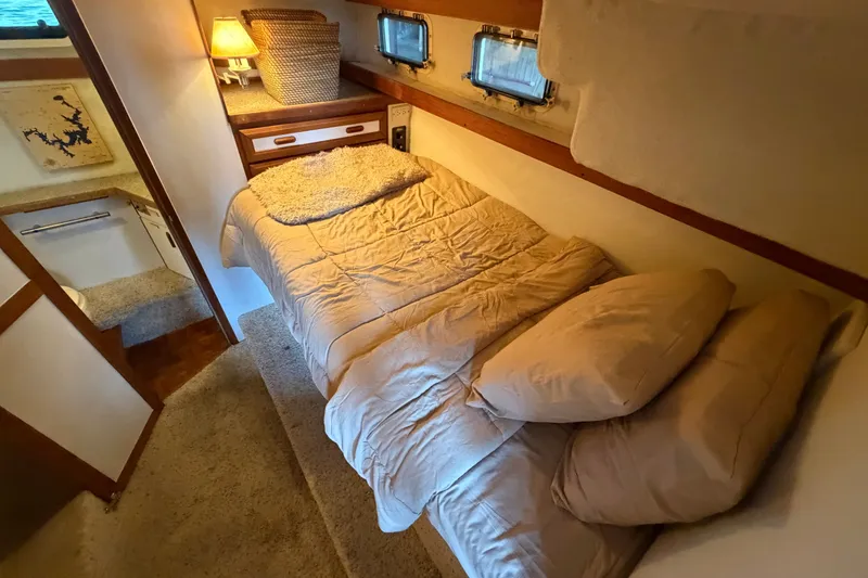 Slide: The Image of Cozy cabin interior of 1987 Carver 32 Aft Cabin Motor Yacht with bed and soft lighting. - 34