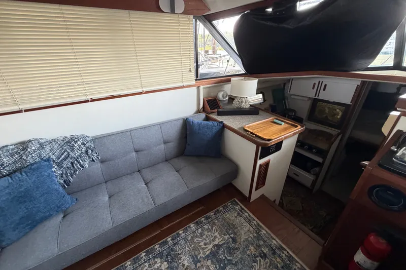 Slide: The Image of Interior of 1987 Carver 32 Aft Cabin Motor Yacht with cozy seating and kitchenette. - 23