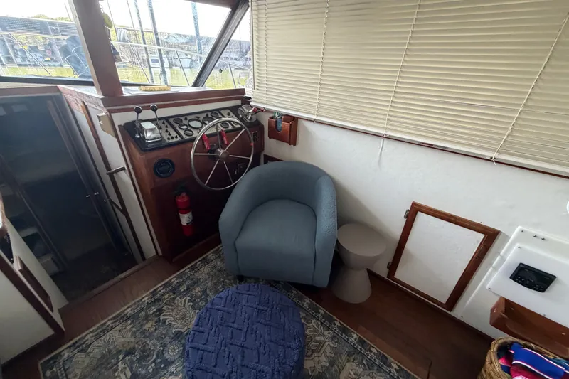 Slide: The Image of Interior of 1987 Carver 32 Aft Cabin Motor Yacht with helm, chair, and decor. - 21