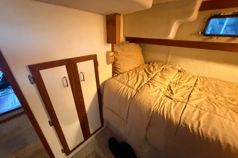 Slide: The Image of Cozy cabin interior of 1987 Carver 32 Aft Cabin Motor Yacht with bed and storage. - 41