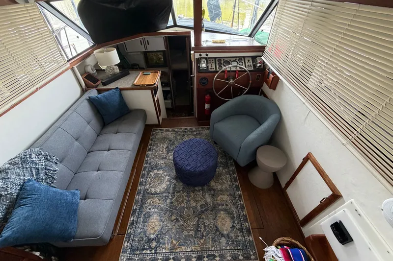 Slide: The Image of Interior of 1987 Carver 32 Aft Cabin Motor Yacht with cozy seating and helm. - 19