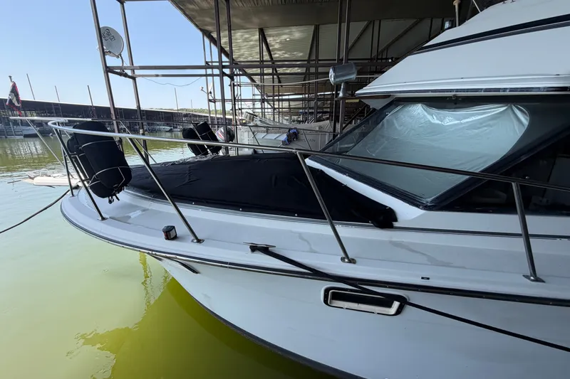 Slide: The Image of 1987 Carver 32 Aft Cabin Motor Yacht docked, featuring sleek design and covered deck. - 9