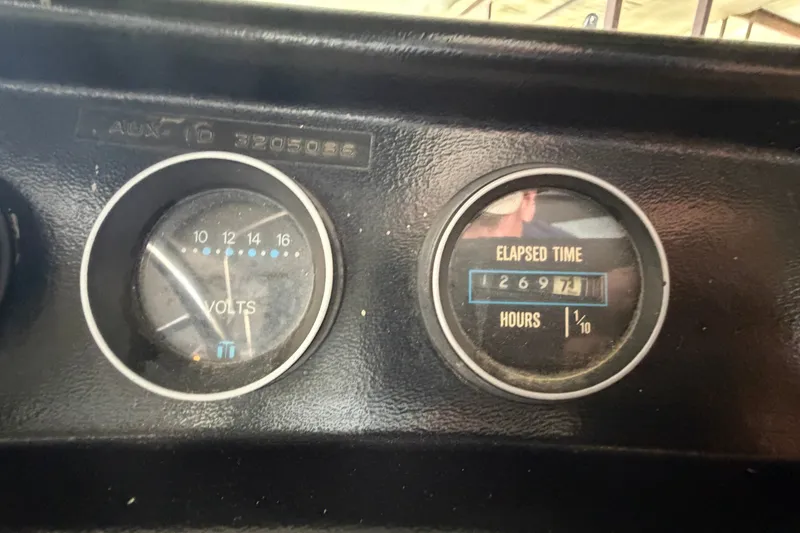 Slide: The Image of Close-up of 1987 Carver 32 Aft Cabin Motor Yacht gauges showing volts and elapsed hours. - 12
