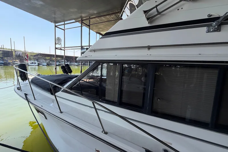 Slide: The Image of 1987 Carver 32 Aft Cabin Motor Yacht docked at marina under shelter. - 8