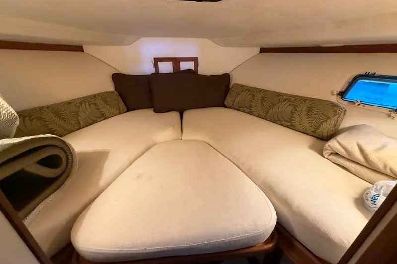 Slide: The Image of Cozy cabin interior of 1987 Carver 32 Aft Cabin Motor Yacht with cushions and window. - 28