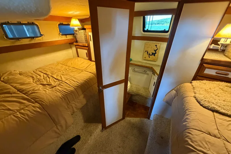 Slide: The Image of Interior of 1987 Carver 32 Aft Cabin Motor Yacht with cozy twin beds and warm lighting. - 37