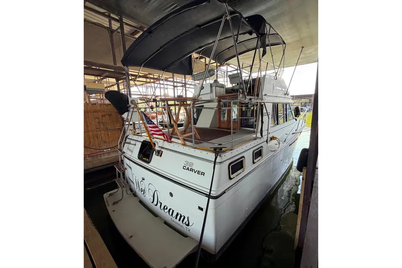 Slide: The Image of 1987 Carver 32 Aft Cabin Motor Yacht docked under shelter. - 2