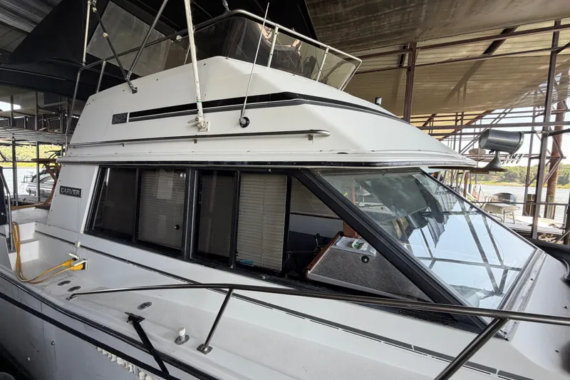 Slide: The Image of 1987 Carver 32 Aft Cabin Motor Yacht docked in a marina. - 4