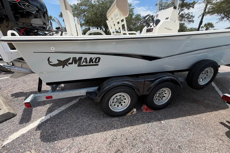 Slide: The Image of 2026 Mako Pro Skiff 19 CC boat on trailer, parked outdoors. - 9