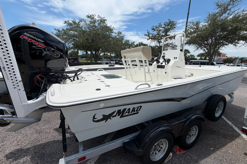 The Image of 2026 Mako Pro Skiff 19 CC boat on trailer, featuring Mercury Pro XS engine. - 0