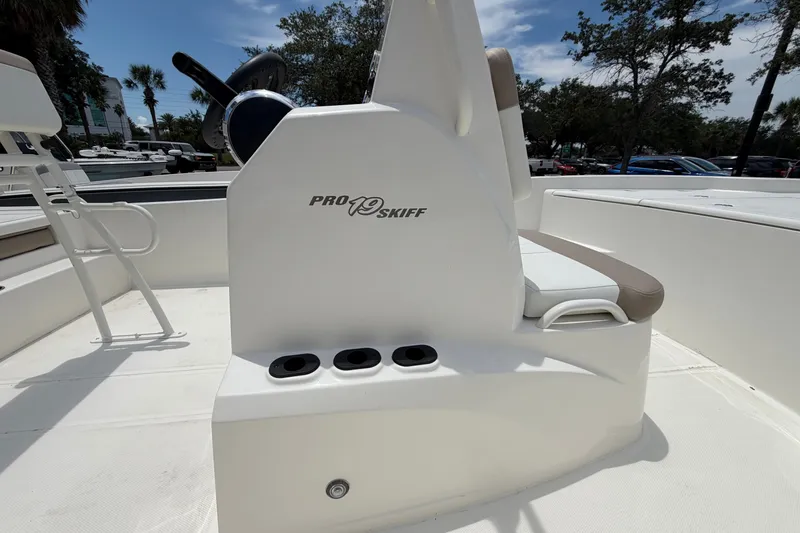 Slide: The Image of 2026 Mako Pro Skiff 19 CC boat interior with steering console and seating. - 5
