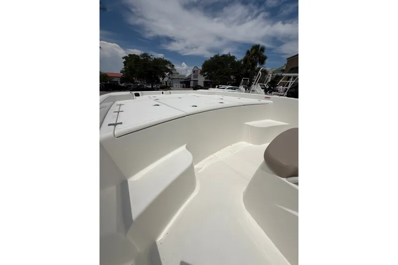 Slide: The Image of 2026 Mako Pro Skiff 19 CC boat deck under a partly cloudy sky. - 8