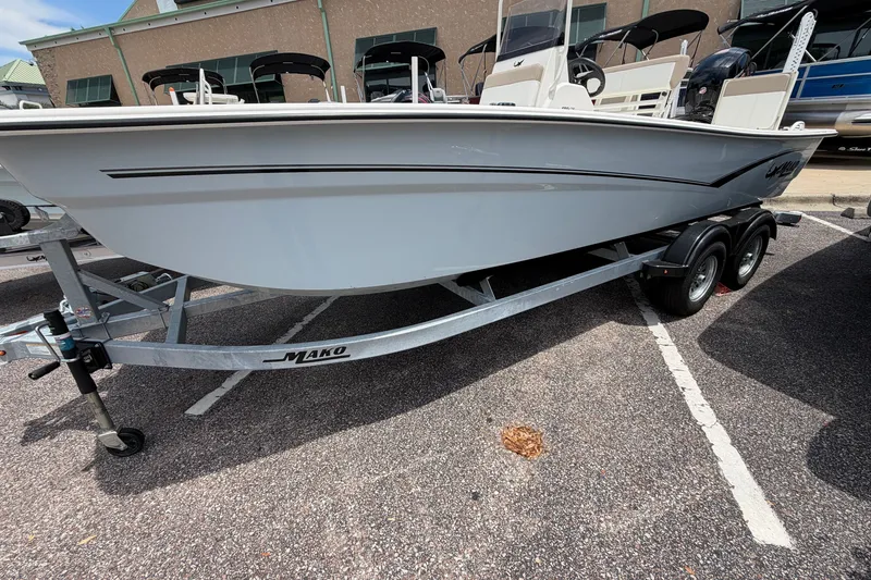 Slide: The Image of 2026 Mako Pro Skiff 19 CC boat on trailer in parking lot. - 1
