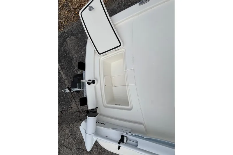 Slide: The Image of 2026 Mako Pro Skiff 13 CC boat with open storage compartment and trolling motor. - 11