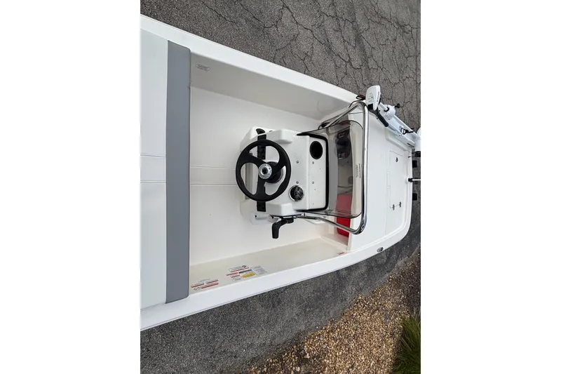 Slide: The Image of 2026 Mako Pro Skiff 13 CC boat interior with steering wheel and console. - 10
