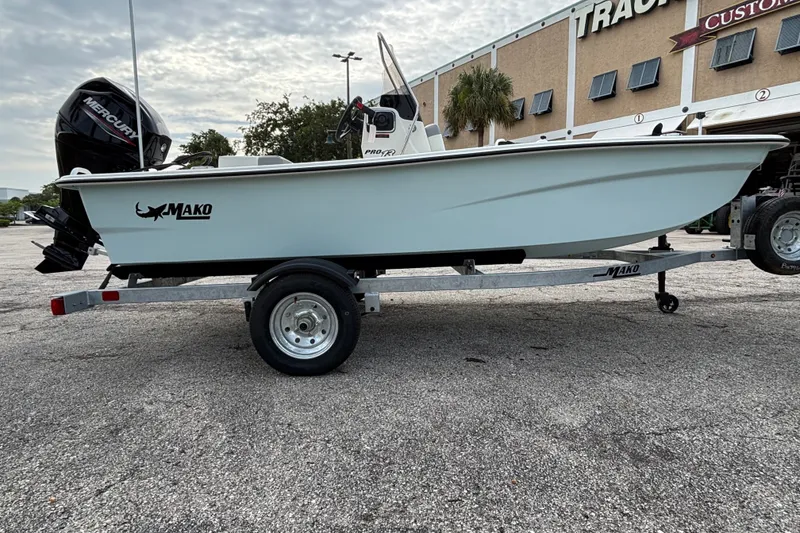 Slide: The Image of 2026 Mako Pro Skiff 13 CC boat on trailer, parked outdoors. - 6